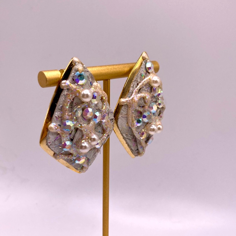 White diamond shape earrings accented with rhinestone stones and pearls